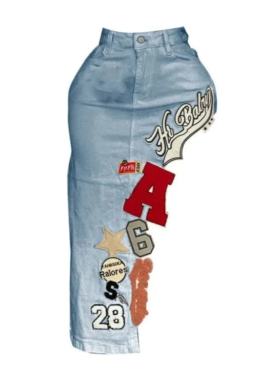 Denim skirt with various patches and text on a white background