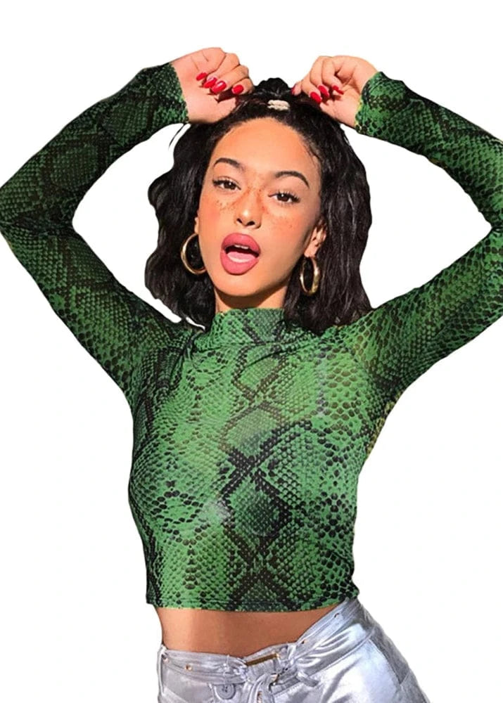 Person wearing a green snake print long-sleeve top on a white background