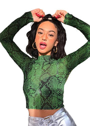 Person wearing a green snake print long-sleeve top on a white background