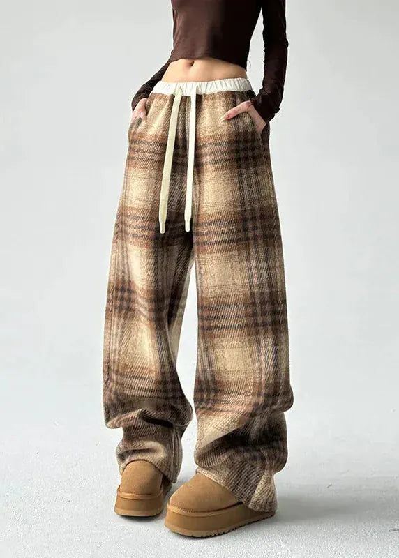 Plaid pants worn by a person on a white background