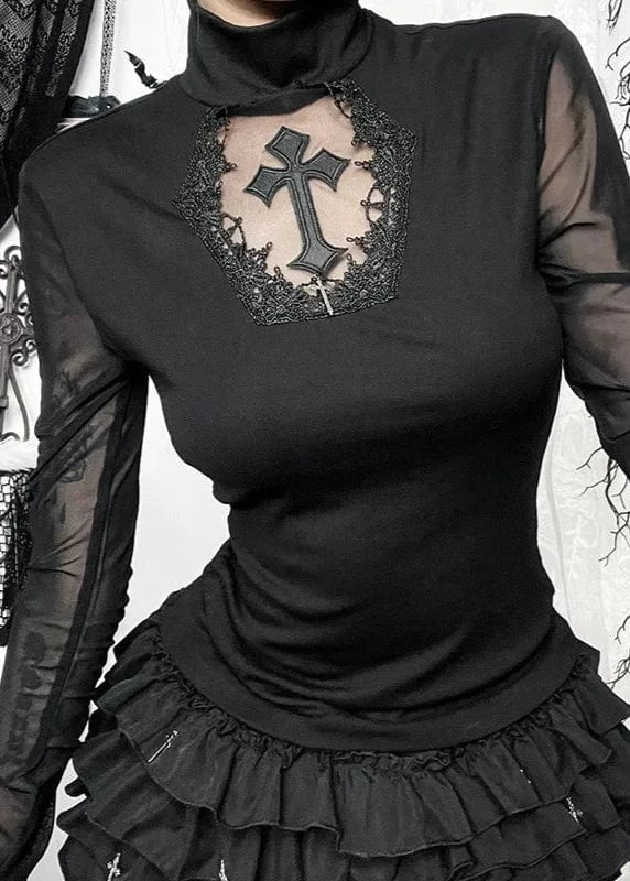 Black long-sleeve top with sheer sleeves and a decorative cross design, worn with a black skirt.