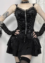 Person wearing a black lace corset and skirt with gloves against a white background