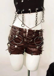 Steampunk-style outfit with leather shorts, chains, and spikes on a mannequin against a white background.