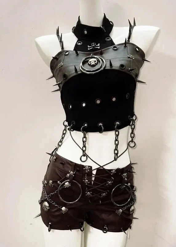 Black leather outfit with spikes and chains on a mannequin against a plain background