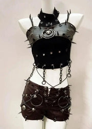 Black leather outfit with spikes and chains on a mannequin against a plain background