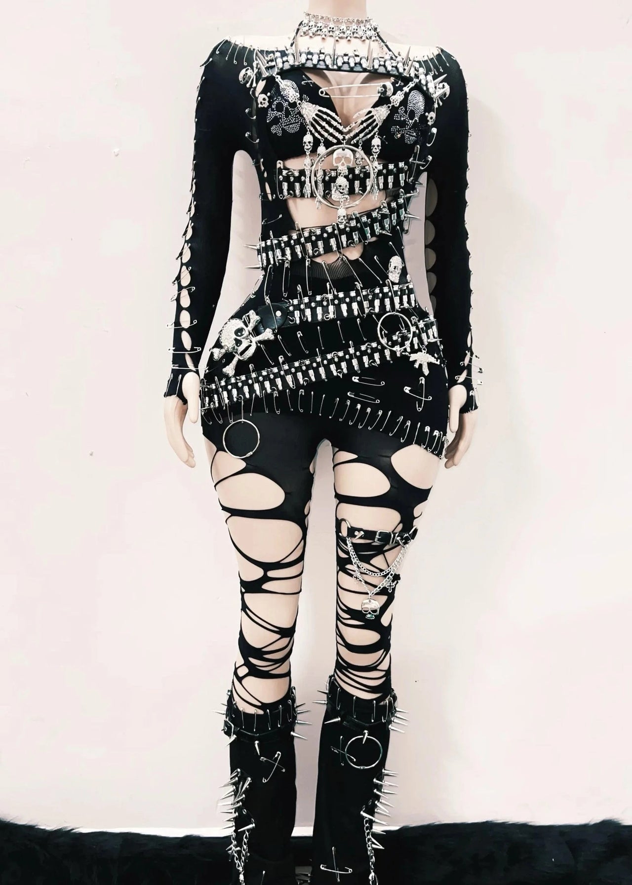 Black and white outfit with intricate design on a mannequin against a white background