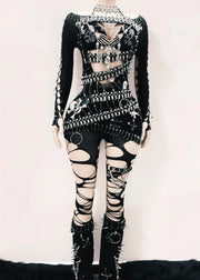 Black and white outfit with intricate design on a mannequin against a white background
