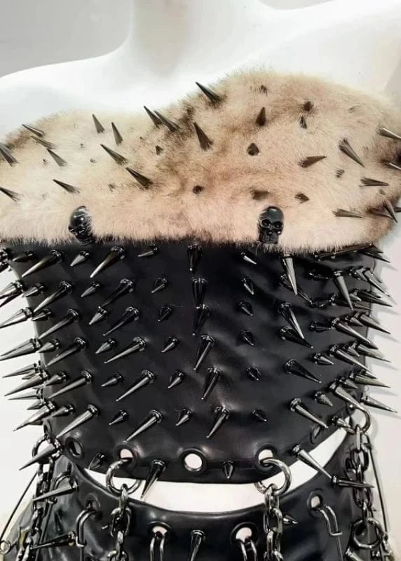 Black spiked leather corset with fur top on a mannequin against a white background