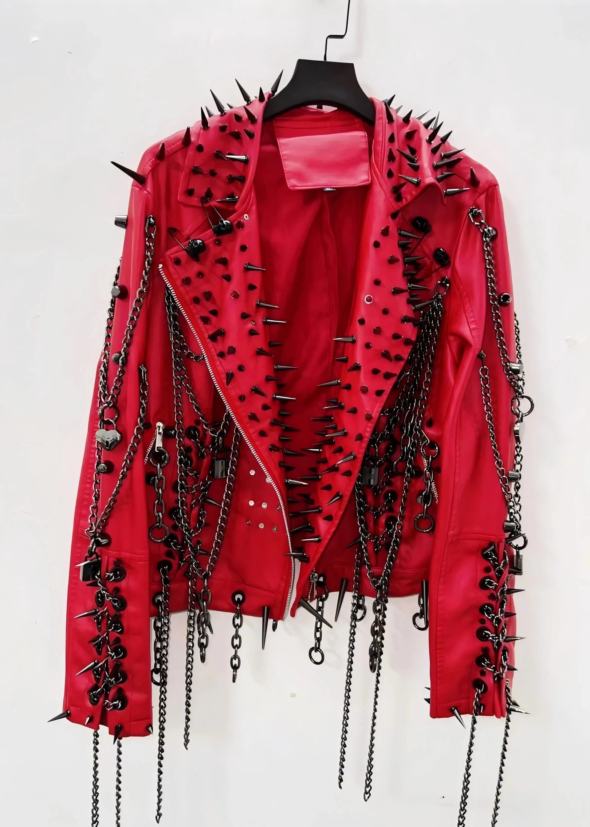 Red leather jacket with black spikes and chains on a white background