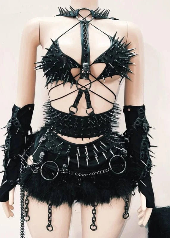 Black gothic outfit with spikes and chains on a plain background