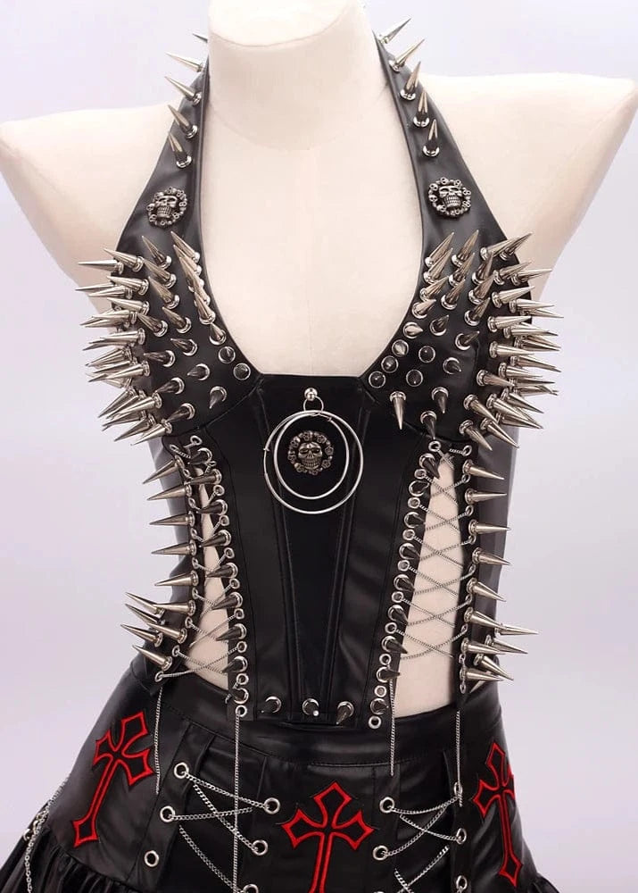 Black leather dress with spikes and red cross designs on a mannequin against a white background