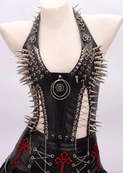 Black leather dress with spikes and red cross designs on a mannequin against a white background