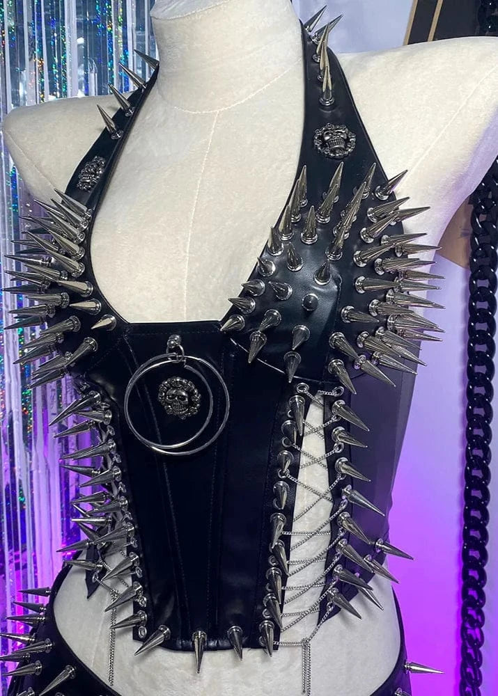 Black leather garment with spikes on a mannequin against a colorful background