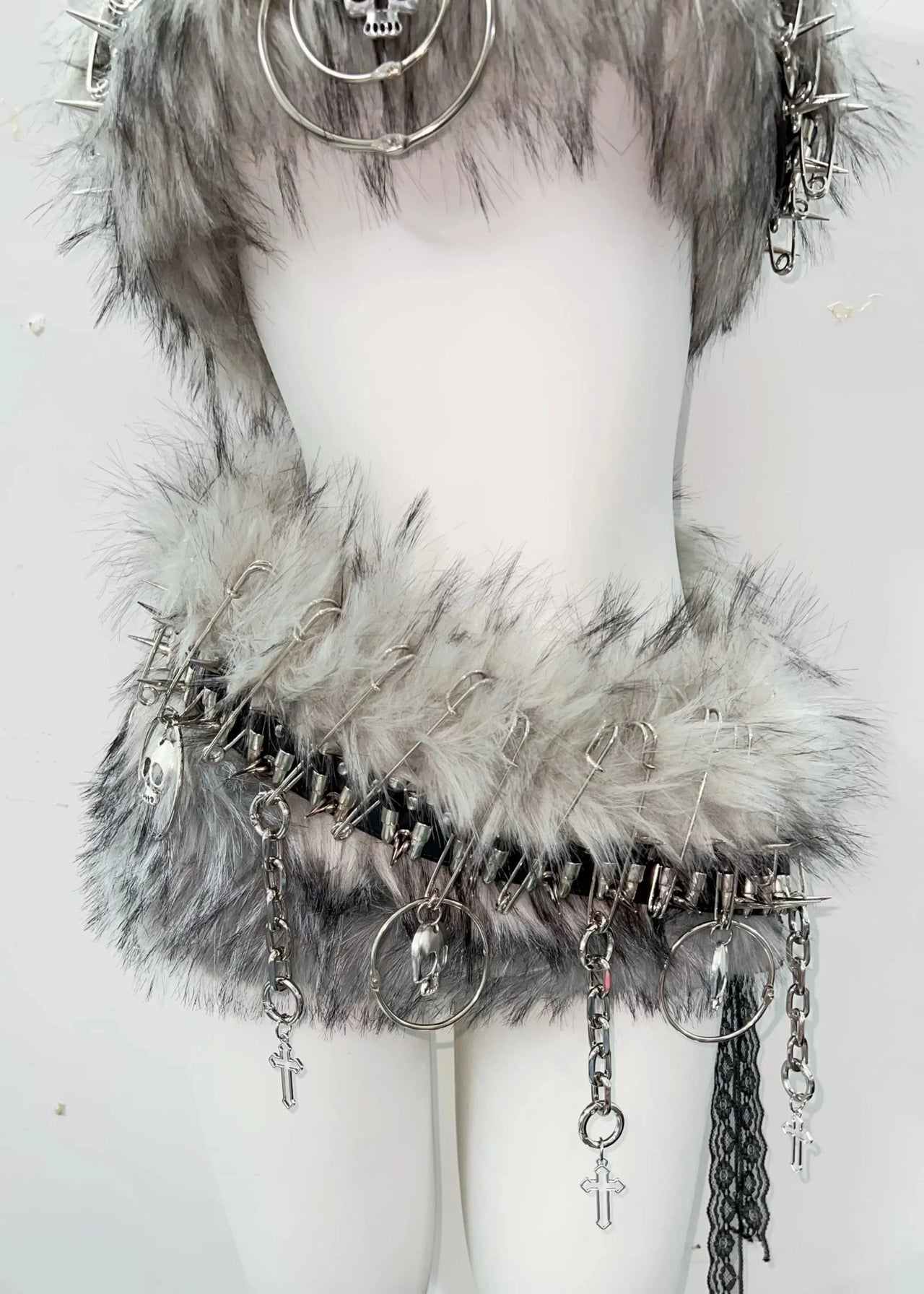 Mannequin with fur-trimmed belt and accessories on a white background