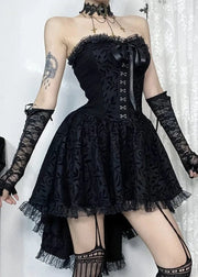Person wearing a black lace dress with long gloves against a white background