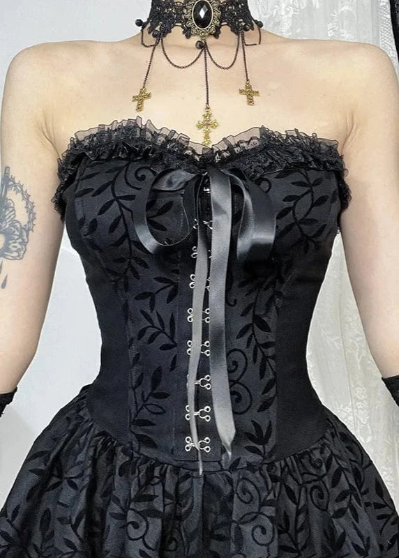 Black lace corset dress with decorative elements on a neutral background