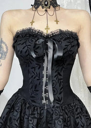 Black lace corset dress with decorative elements on a neutral background