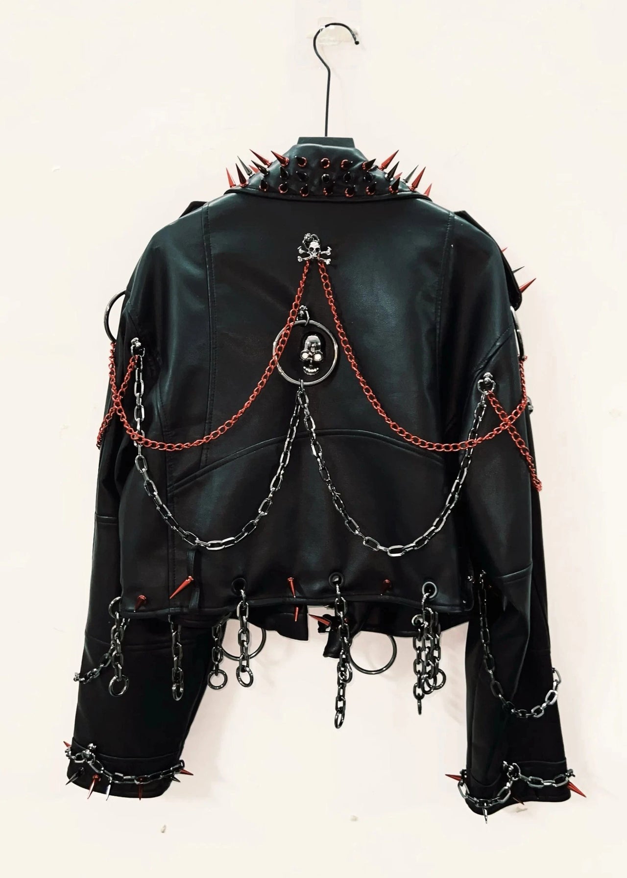 Black leather jacket with chains and spikes on a white background