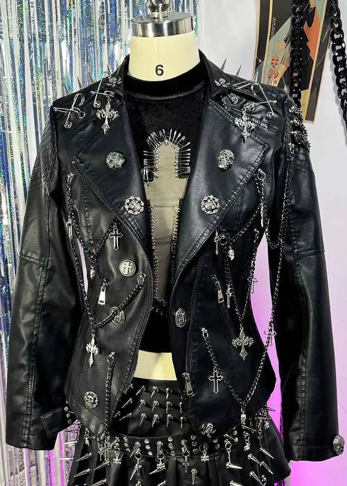 Black leather jacket with studs and crosses on a mannequin against a colorful background