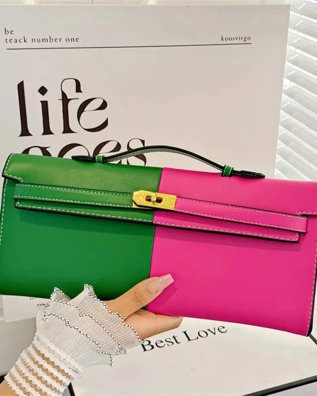 Two-tone green and pink handbag held by a person with a magazine in the background.