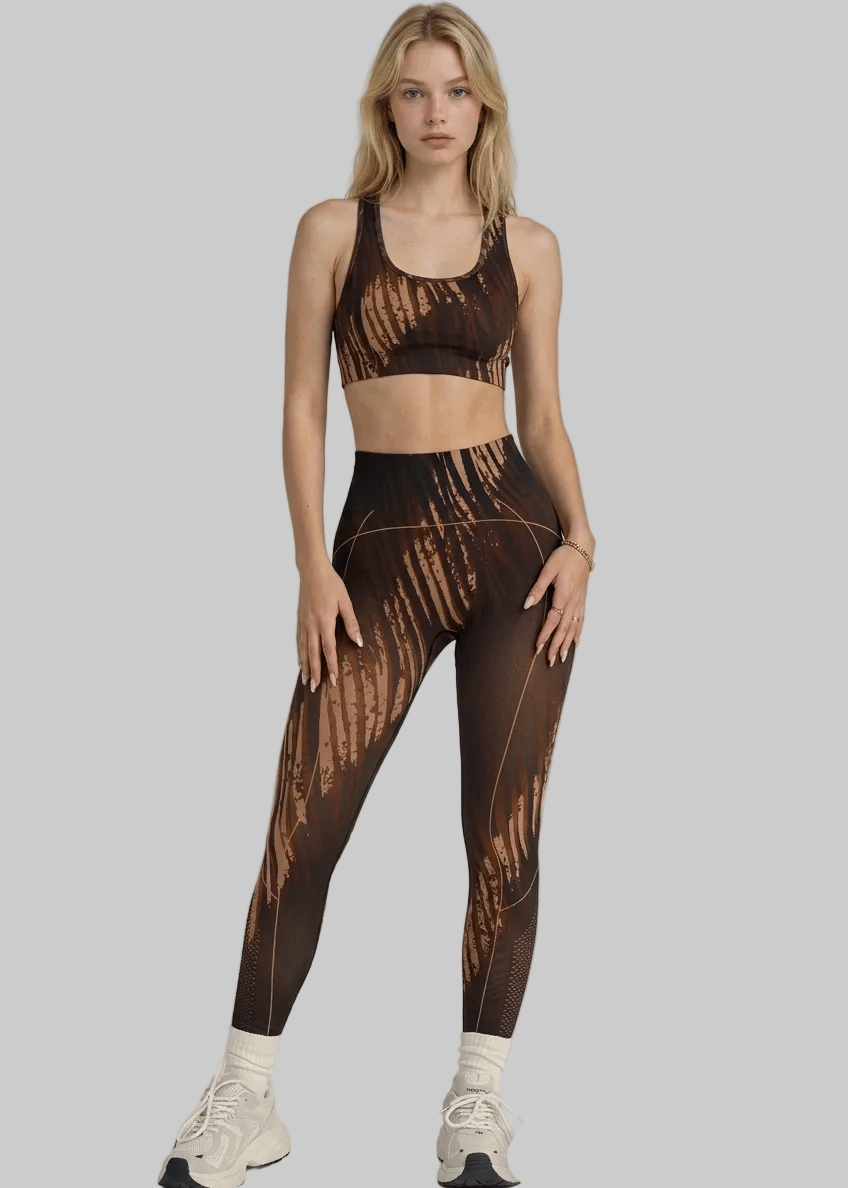 Woman wearing a brown patterned sports bra and leggings set on a gray background with 'arvin' branding.