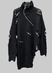 Black distressed sweater with metal hardware on a metallic background