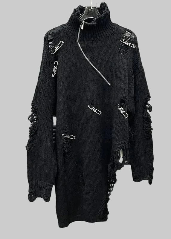 Black distressed sweater with metal hardware on a metallic background