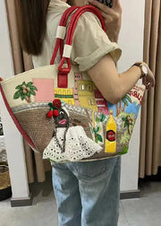 Person holding a colorful handbag with various designs and text.