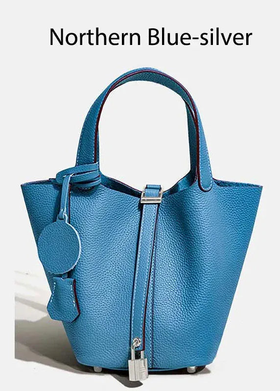Blue handbag with silver accents on a white background