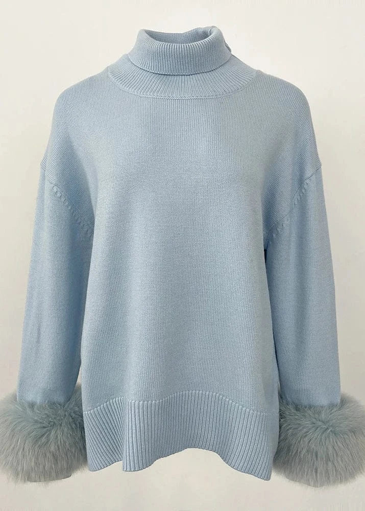 Light blue sweater with gray fur cuffs on a white background