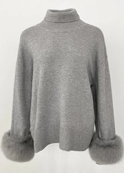 Gray sweater with fur cuffs on a white background