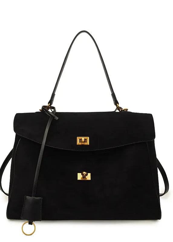 Black handbag with gold accents on a white background