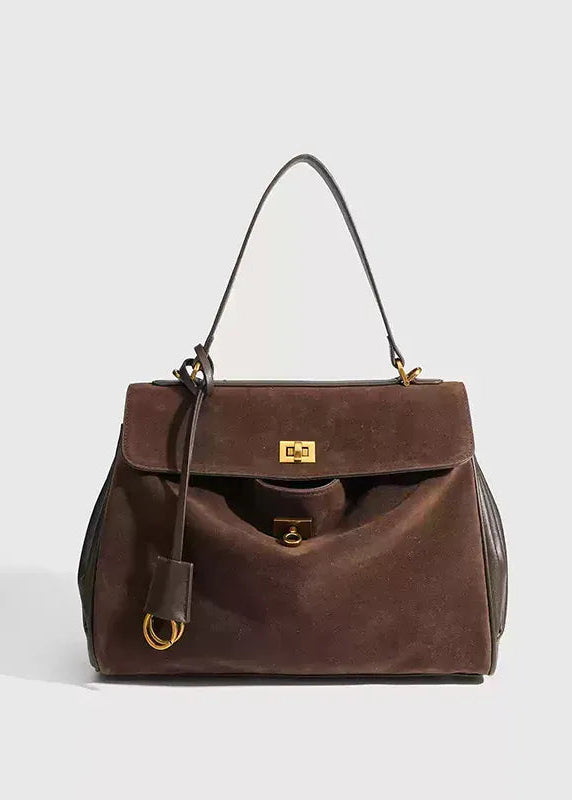 Brown handbag with gold accents on a light gray background