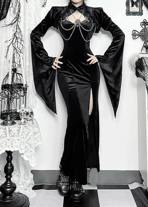 Person wearing a black gothic outfit in a decorated room with candles and lace.