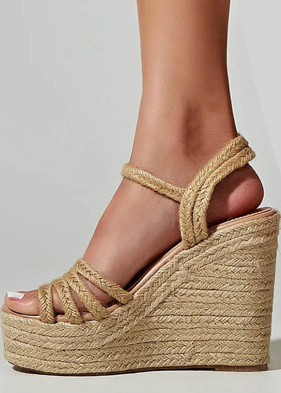 Beige wedge sandal with rope detailing on a neutral background