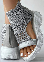 Gray crochet sandals with white soles on a light gray background