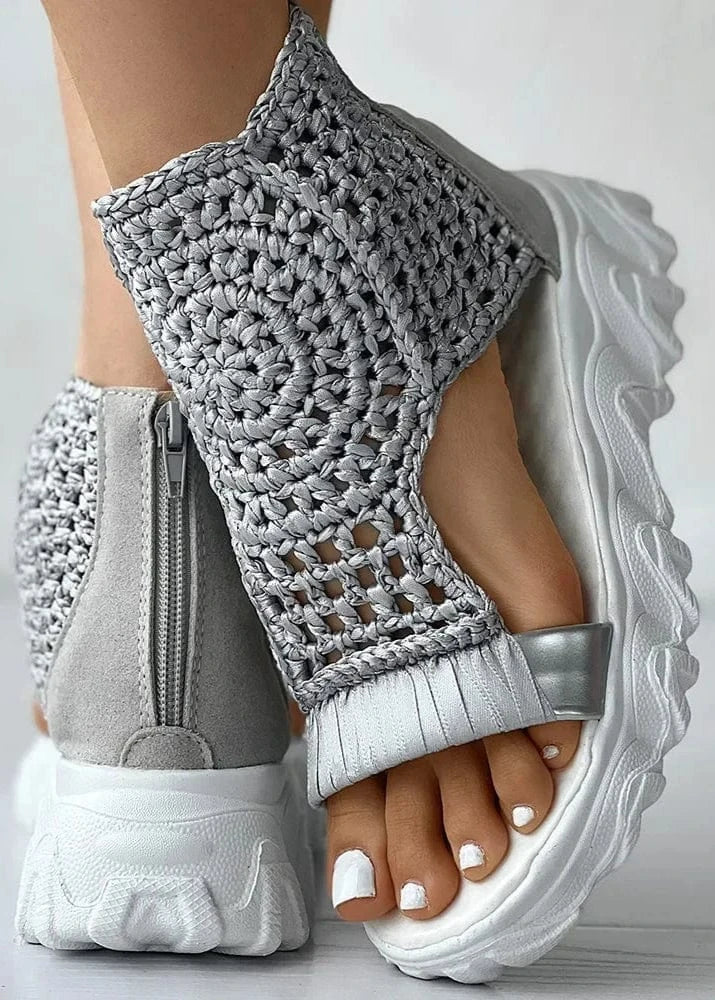 Gray crochet sandals with white soles on a light gray background