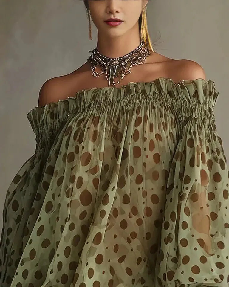 Woman wearing a green off-shoulder top with brown polka dot pattern against a neutral background