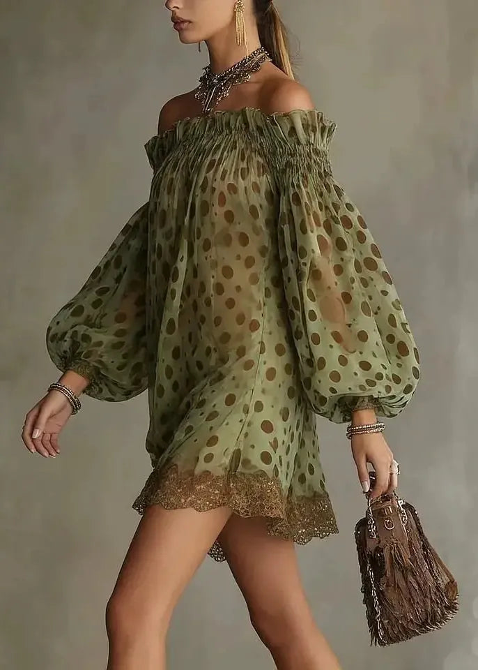 Woman wearing a green polka dot dress holding a brown handbag against a neutral background