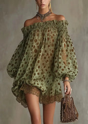 Woman wearing a green off-shoulder dress with brown polka dots against a gray background