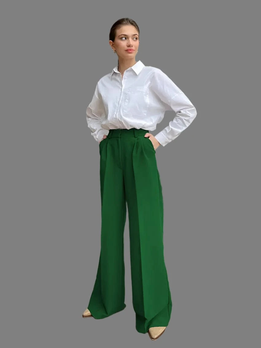 A woman modeling a casual outfit, wearing wide leg pants in beige and a white sweater.