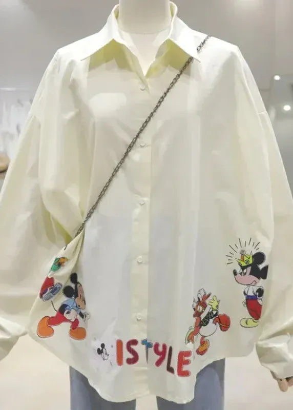 White shirt with cartoon character designs and 'ISTYLE' text on a mannequin.