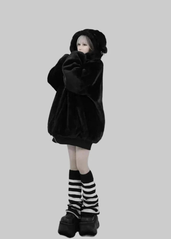 Person wearing a black oversized hoodie and striped socks on a white background with 'Lautaro' branding.