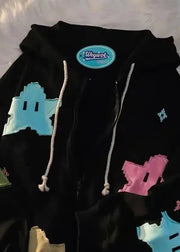 Black hoodie with colorful geometric shapes on a textured surface