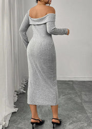 Woman wearing a gray off-shoulder dress with long sleeves in a room.