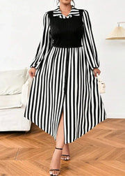 Woman wearing a black and white striped dress with a high slit, standing in a room with a white couch and wooden floor.