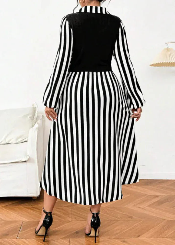 Person wearing a black and white striped dress in a room with a white couch and wooden floor.