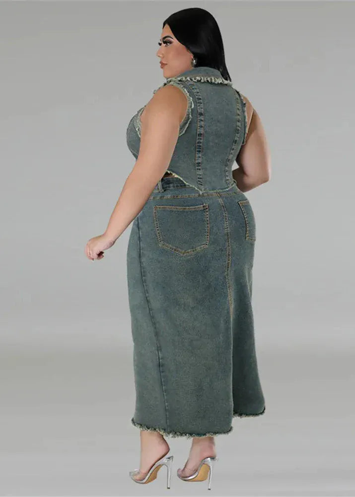 Woman wearing a denim dress against a gray background