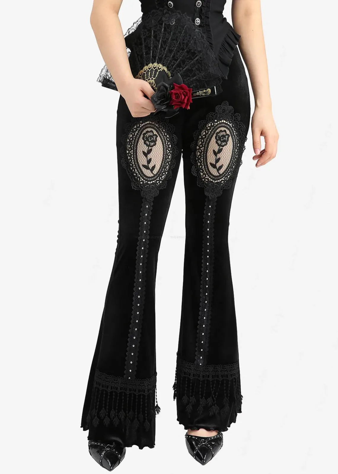Black flared pants with decorative elements on a white background