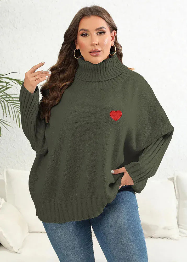 Woman wearing a green sweater with a red heart design on a white background